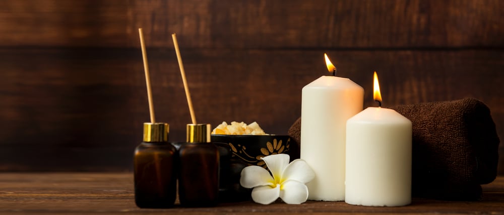 Candles and oil on a board